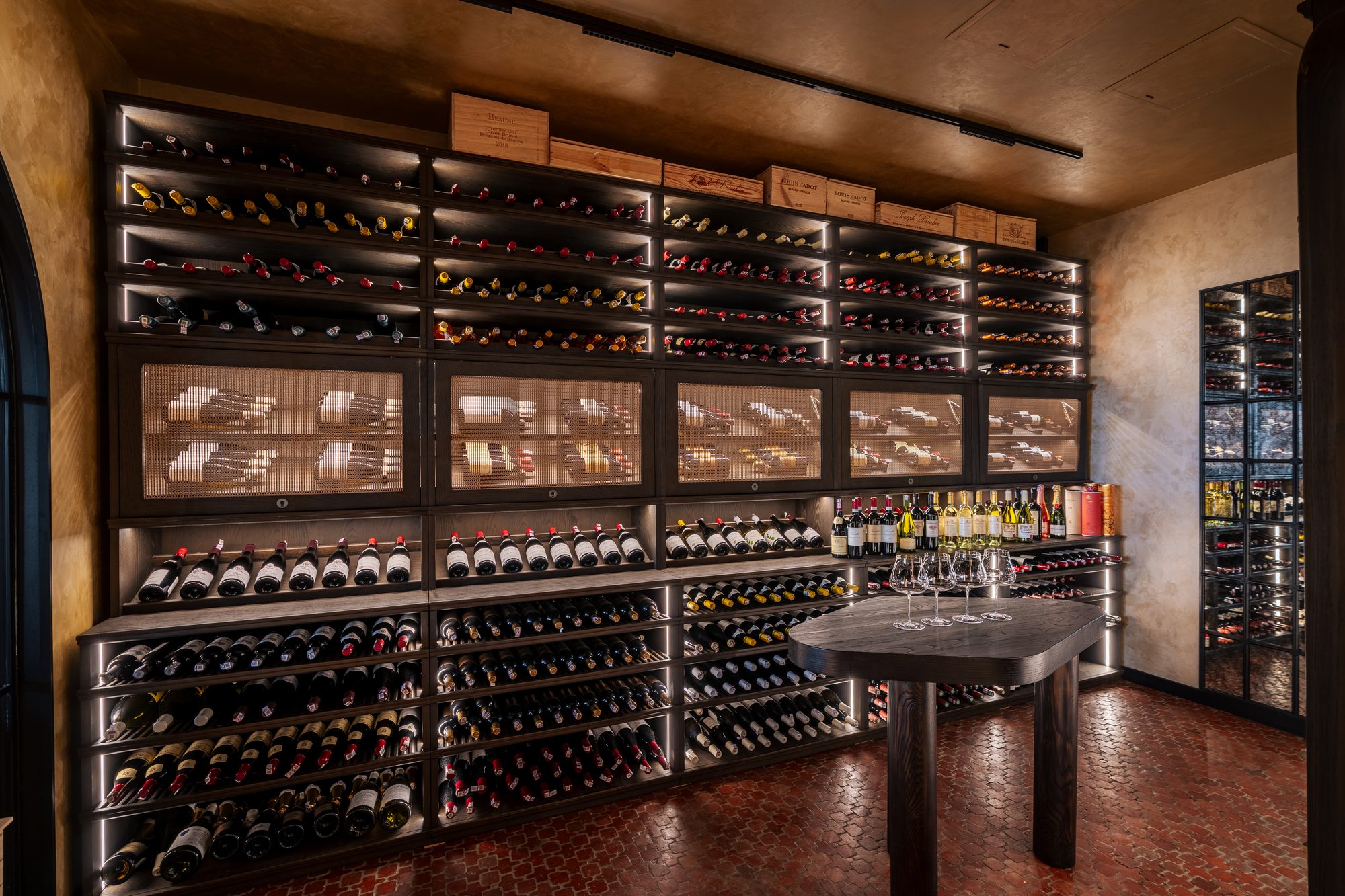 Floor-to-ceiling wine racks running the length of the Maison Rouge cellar